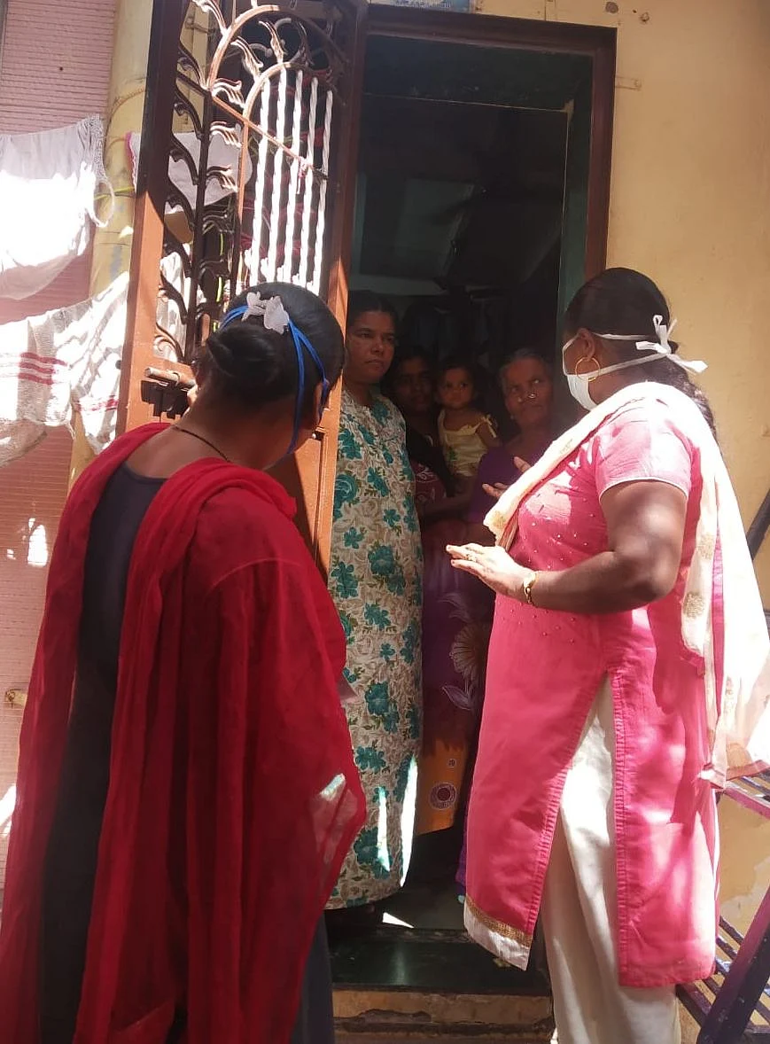 Ujjwala Gholap (right) pays a visit to a family. 