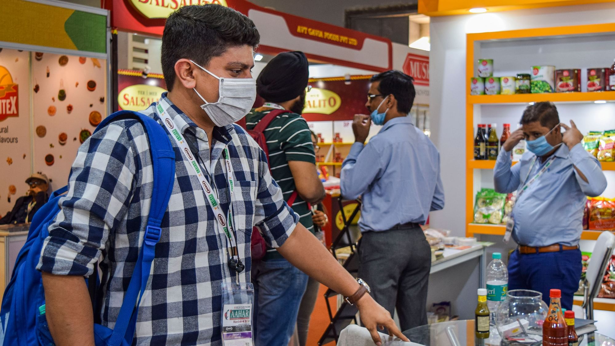 Visitors and exhibitors wear protective masks in wake of the deadly novel coronavirus during the 35th edition of AAHAR, at Pragati Maidan, in New Delhi, Tuesday, March 3, 2020.