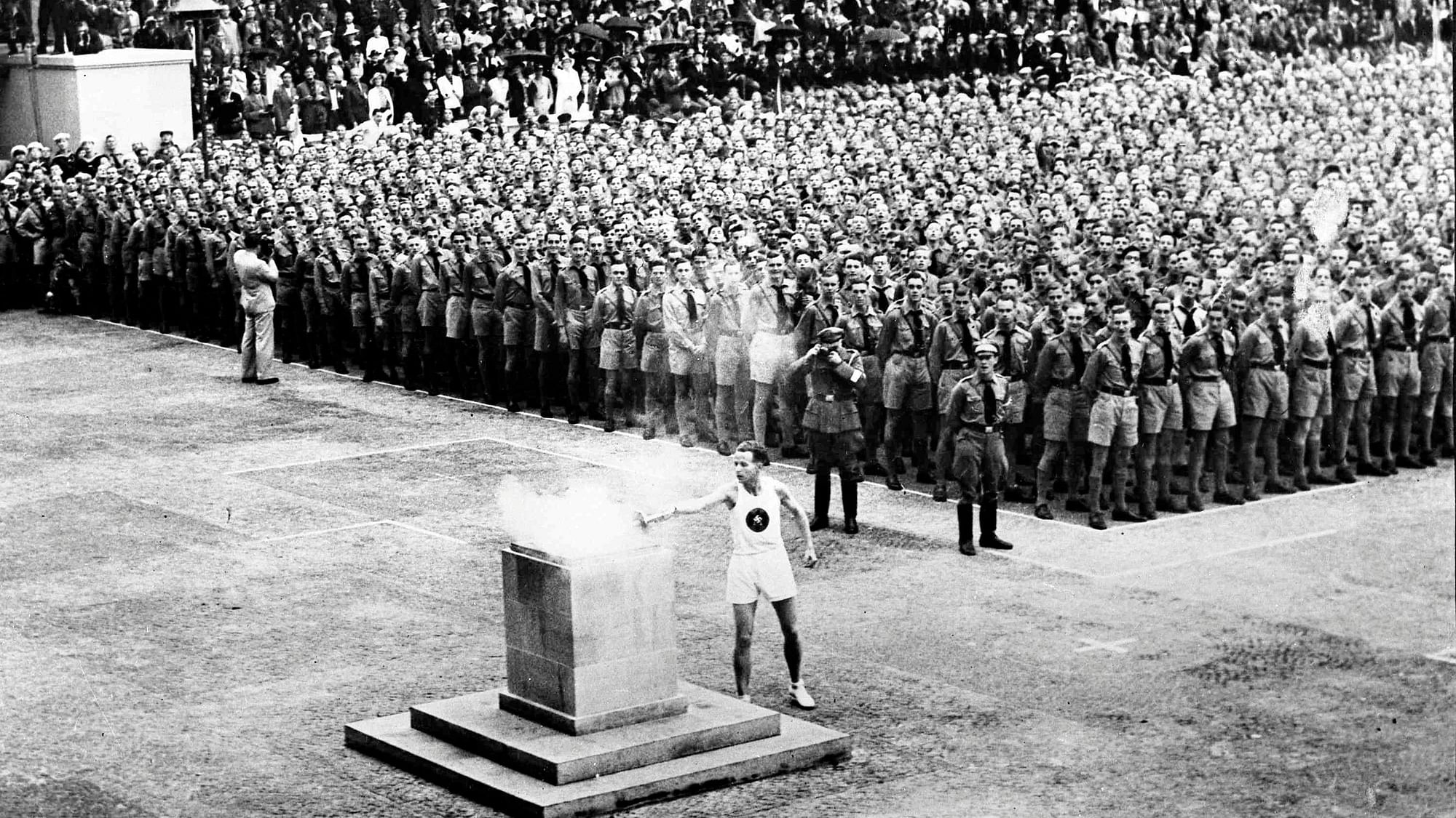The lighting of the Olympic fire in Lustgarten, Berlin on Aug. 1, 1936, where it will be guarded by members of the Hitler Youth until it is brought to the Olympic stadium for the opening of the games in the afternoon.