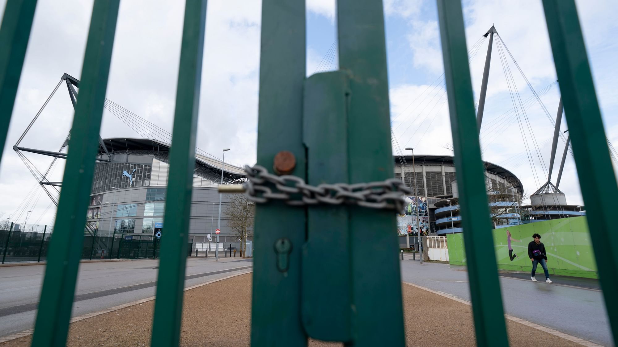 A locked gate is seen by the Etihad Stadium where Manchester City was due to play Burnley in an English Premier League match Saturday March 14, 2020.