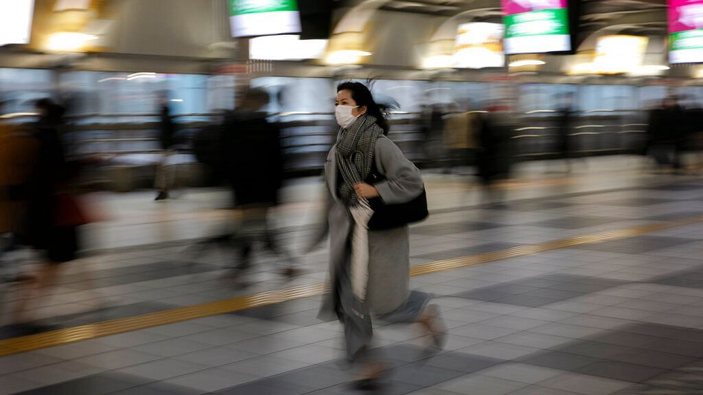 A woman hurries to a platform at the Shinagawa Station in Tokyo, Monday, 2 March, 2020.