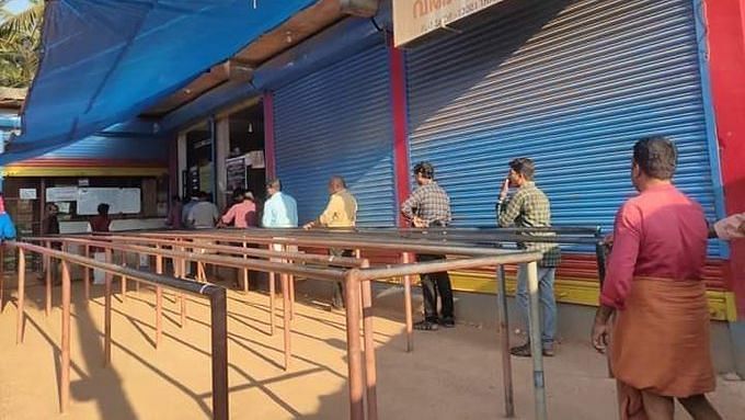 People line up outside alcohol store in Kerala.