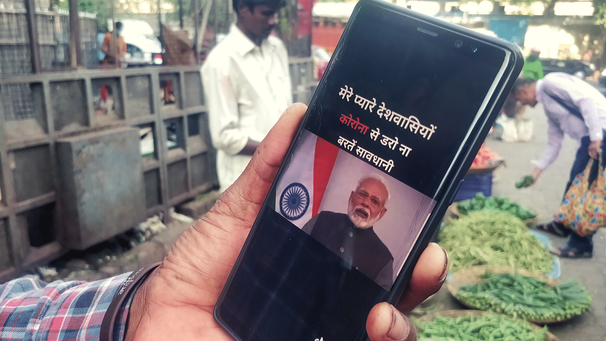 Monu shows a video on his mobile phone, of Prime Minister Modi speaking about coronavirus.