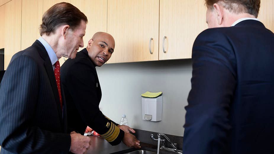 US Surgeon General Vice Admiral Jerome M Adams, center, demonstrates hand-washing on 2 March.