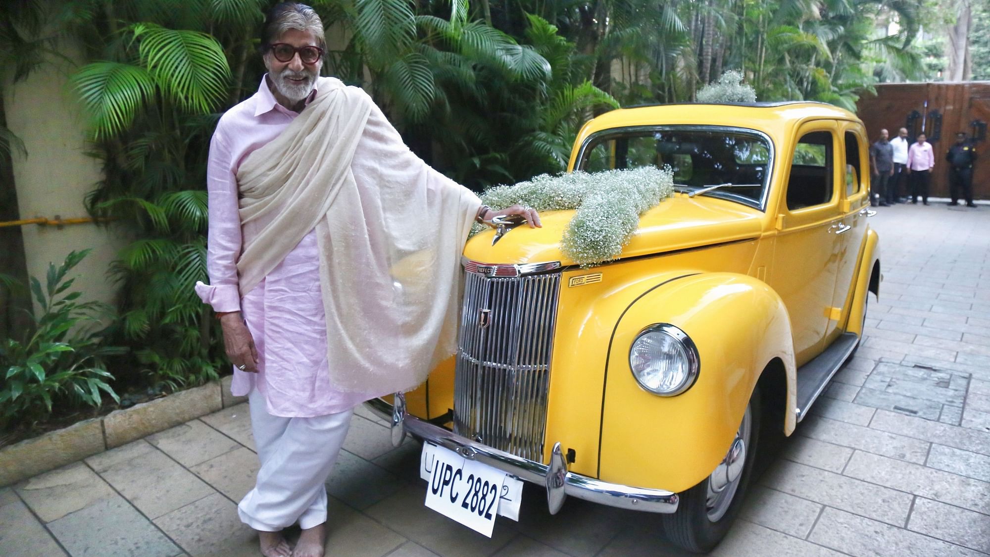 Amitabh Bachchan strikes a pose with the car.