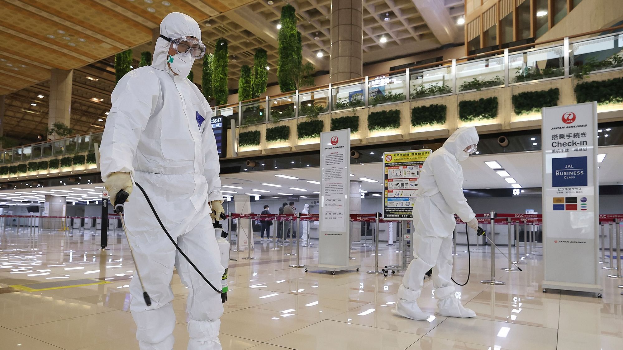 Workers spray disinfectant as a precaution against the coronavirus at the Gimpo Airport in Seoul, South Korea.