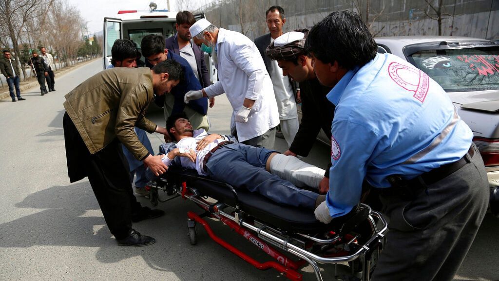 An injured man is carried into an ambulance after an attack in Kabul, Afghanistan, on Friday, 6 March, 2020.