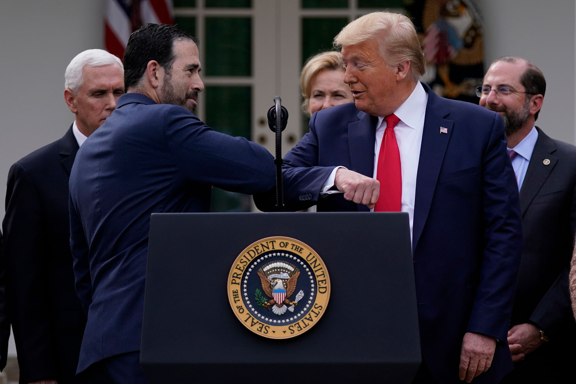 LHC Group’s Bruce Greenstein elbow bumps with President Donald Trump during a news conference about the coronavirus in the Rose Garden at the White House, Friday, 13 March, 2020, in Washington. 