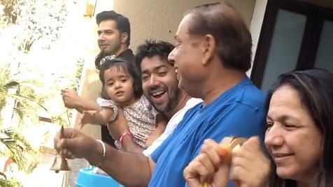 Varun Dhawan with his family on the balcony of their home.