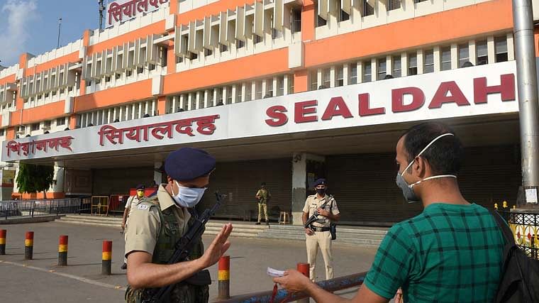 A security person, checks identity card of a man in front of the closed Sealdah Railway Station during lockdown in the wake of coronavirus pandemic, in Kolkata. Image used for representation.