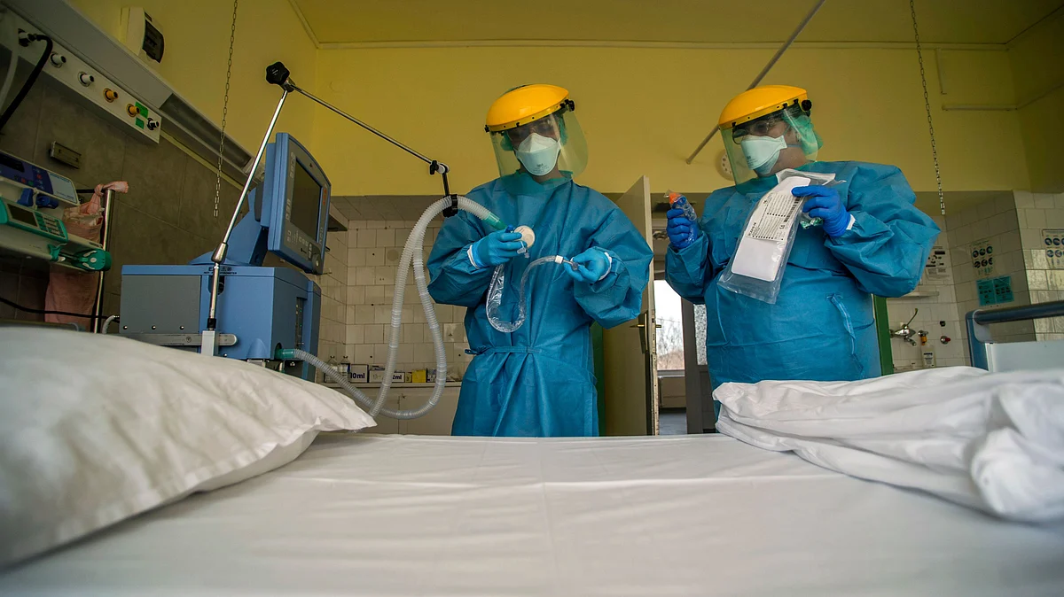 Medical staff members check a ventilator in protective suits at the care unit of the new COVID-19 infected patients in Budapest, Hungary.