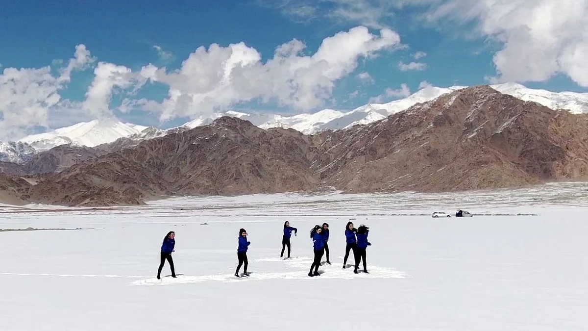 Kids dancing in snow.