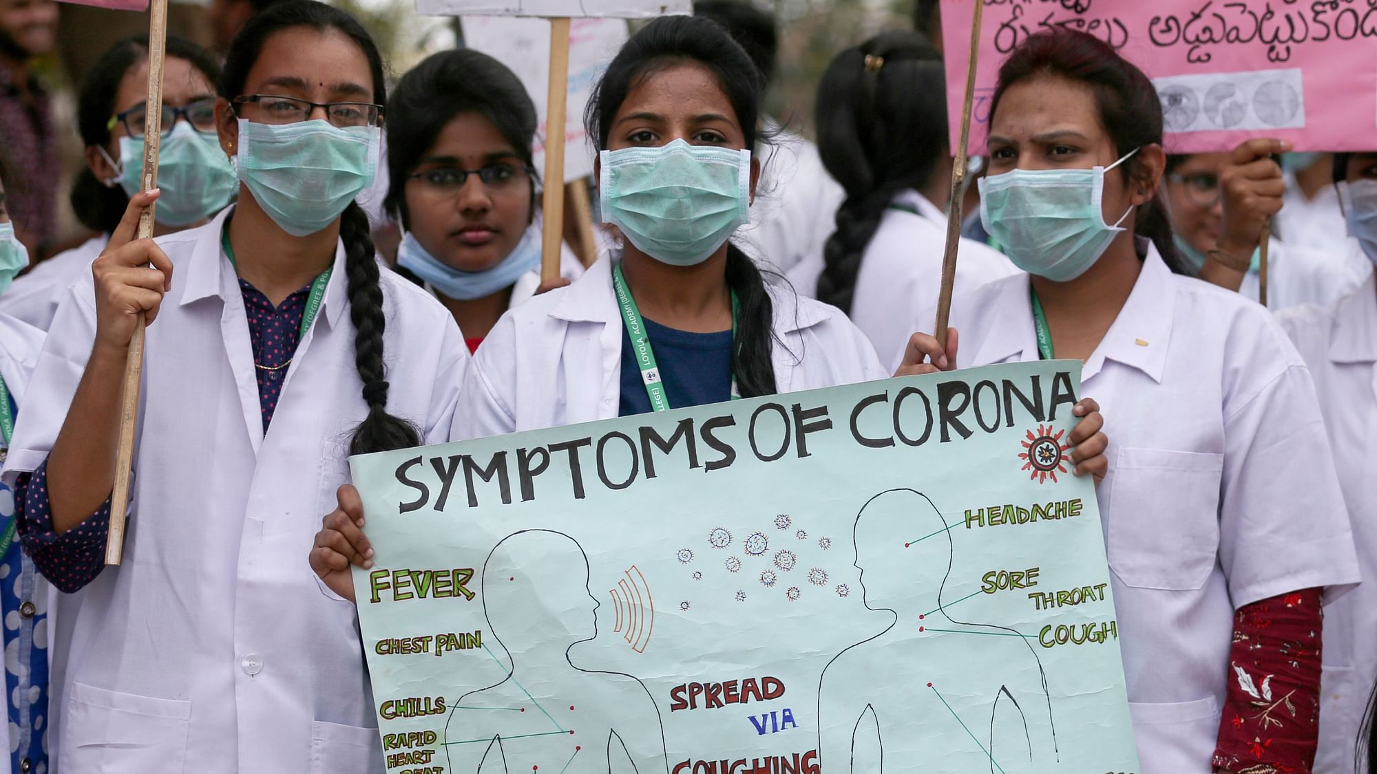 Indian students hold a placard during an awareness rally for COVID-19 in Hyderabad, India on Friday, 6 March 2020.
