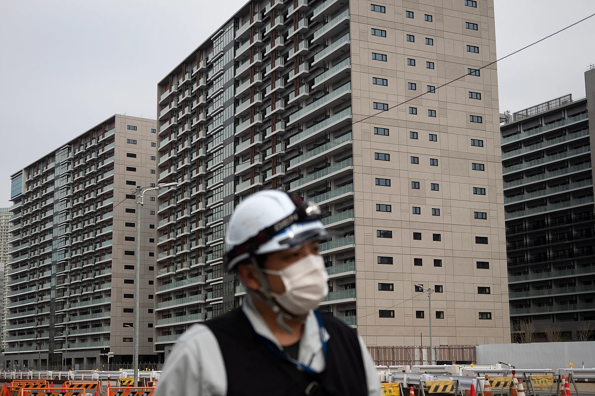 A worker walks through the athletes’ village for the Tokyo 2020 Olympics, in Tokyo, Monday, 23 March 2020.