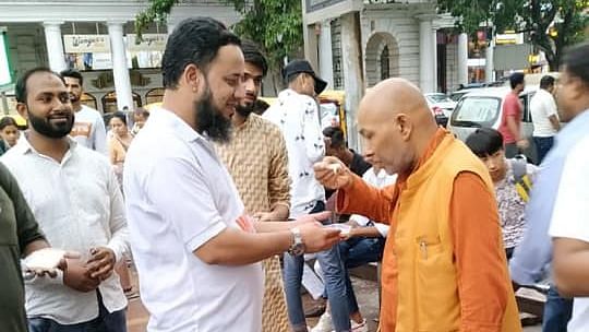(United Against Hate activist Khalid Saifi distributing Kheer on Eid)
