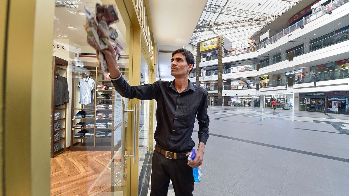 A worker cleans the glass windows of a showroom at a mall in the wake of the coronavirus pandemic. Image used for representational purposes.