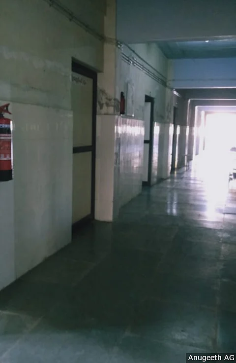 The corridor leading to isolation rooms in Pathanamthitta’s General Hospital. The windows in the ward are open to allow in fresh air, the only view of the world outside for the patients and the staff.