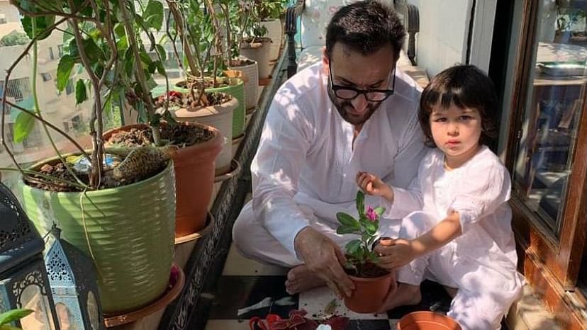 Kareena shares a photo of Saif and Taimur potting plants at home.&nbsp;