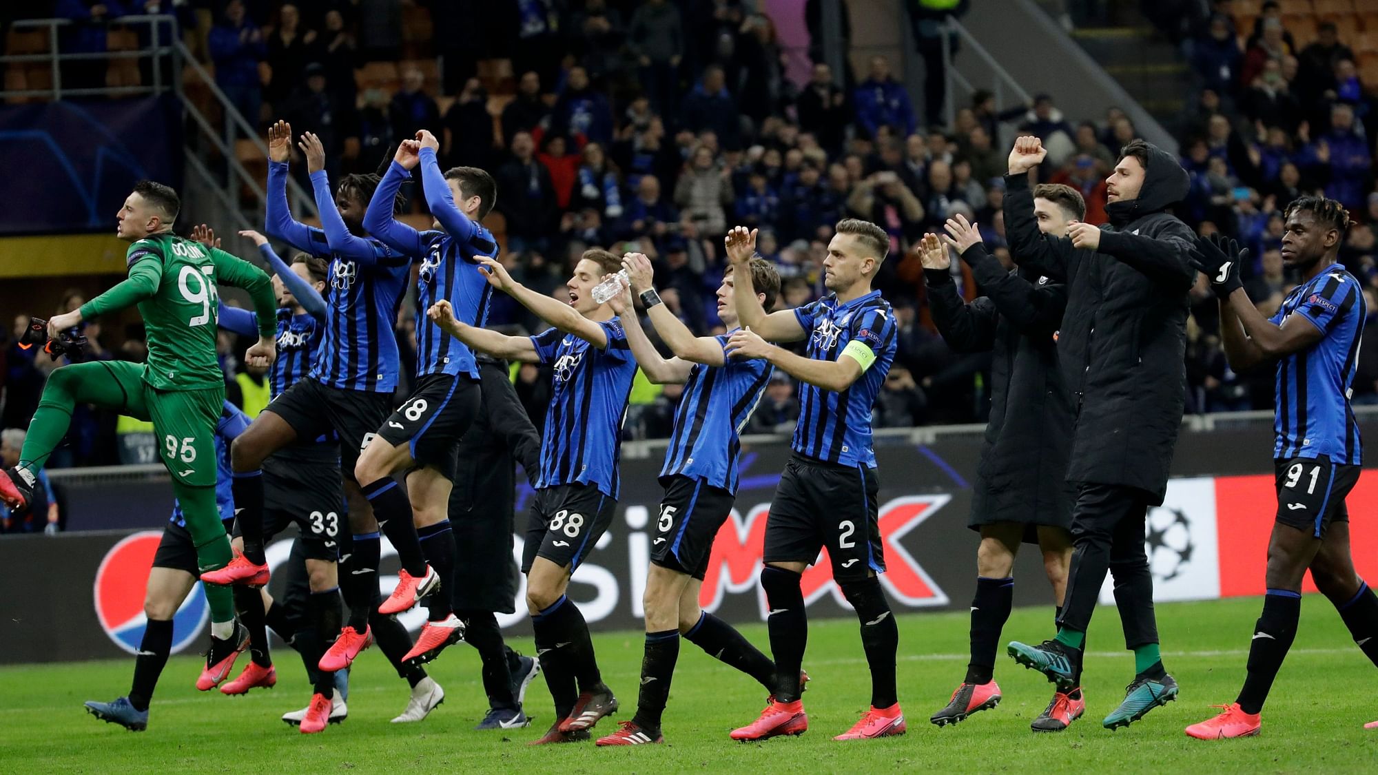 In this Wednesday, Feb. 19, 2020 file photo, Atalanta players celebrate at the end of the Champions League round of 16, first leg, soccer match between Atalanta and Valencia at the San Siro stadium in Milan, Italy.&nbsp;