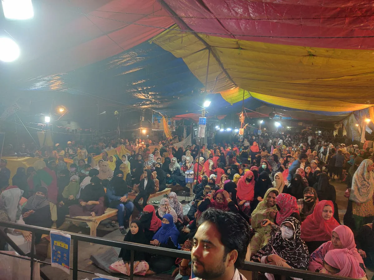 By evening, as the crowd swelled, the women were sitting on the floor. Some women were also seen wearing masks.
