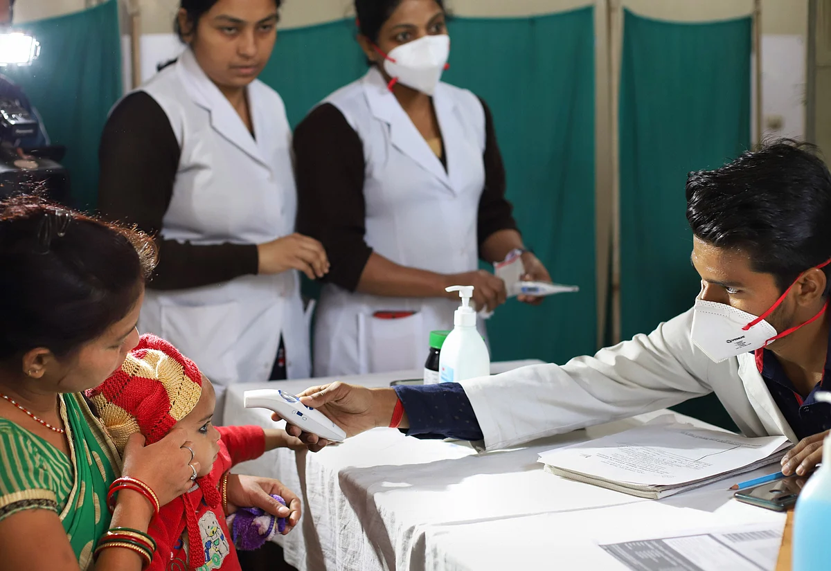 A medic conducts screening of a patient as part of a precautionary measure for novel coronavirus (COVID-19) outbreak, at a government run hospital in New Delhi.