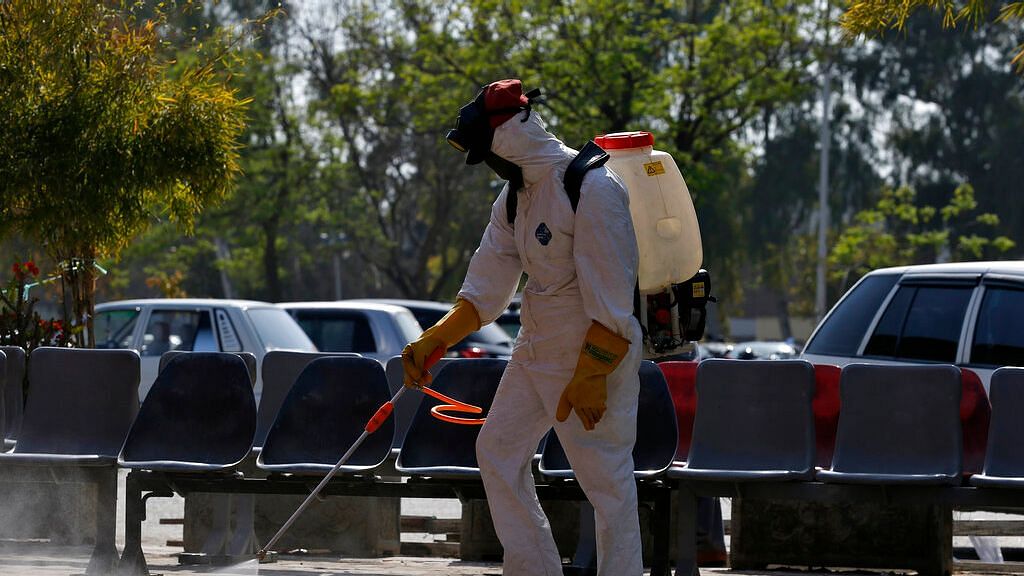 A worker wears protective gears disinfect an area as a precaution against the new coronavirus at the Pakistan Institute of Medical Sciences hospital in Islamabad, Pakistan, Tuesday, 17 March, 2020.