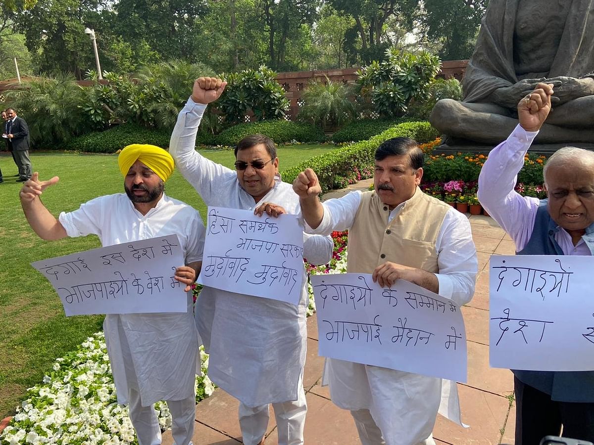 Opposition MPs staged separate dharnas  in Parliament, demanding answers from the government on the Delhi violence.