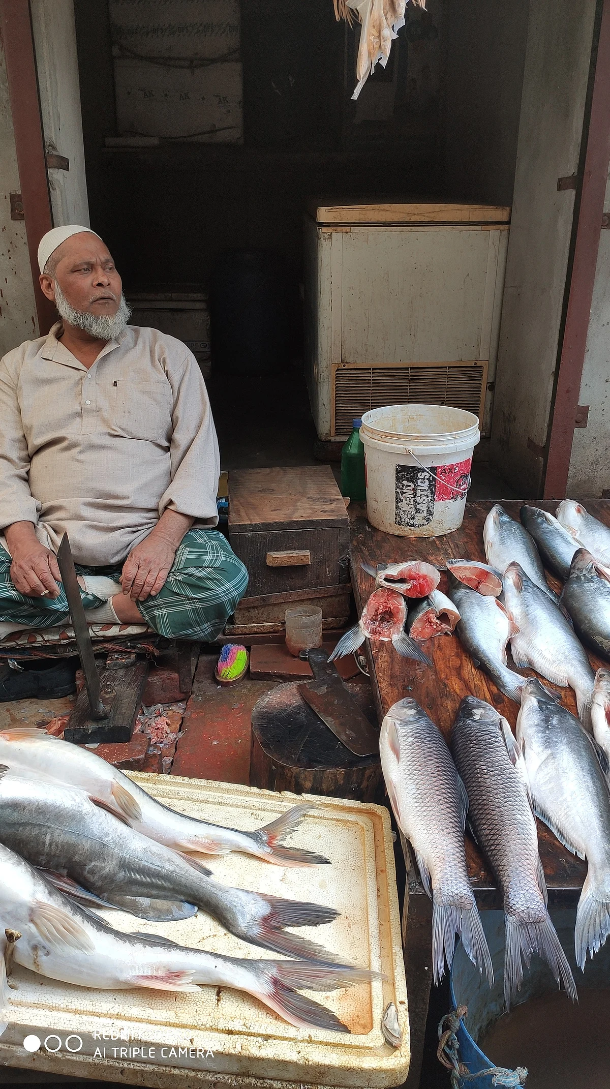 Mohd Akram sits idle at his shop.