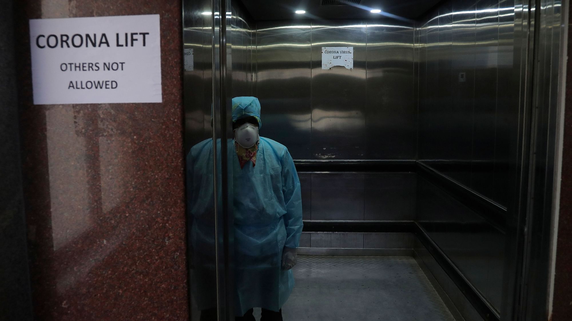 A lift operator stands inside a dedicated lift for people suspected to be infected with the new coronavirus at the Government Gandhi Hospital in Hyderabad, 2 March 2020.