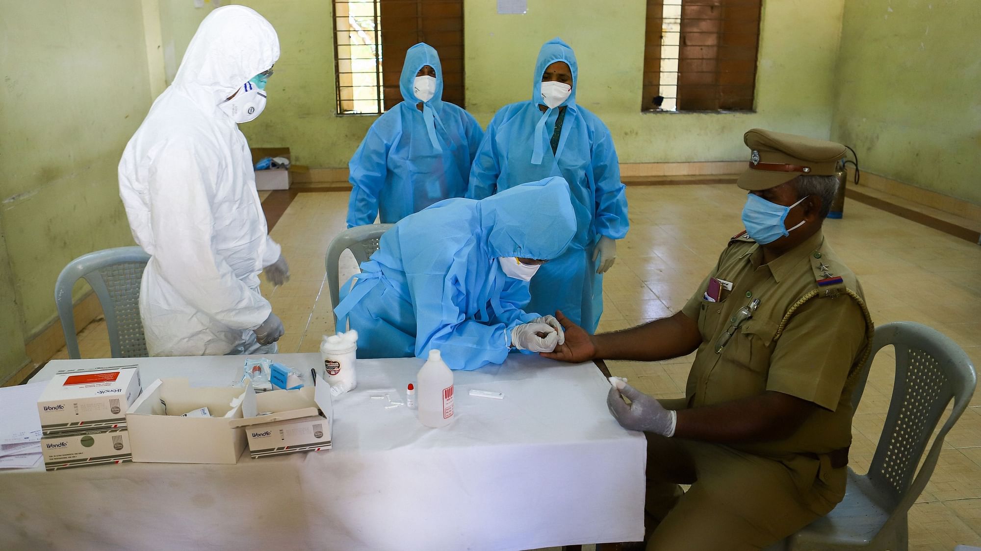 A police officer gives a sample for the rapid test in Chennai.
