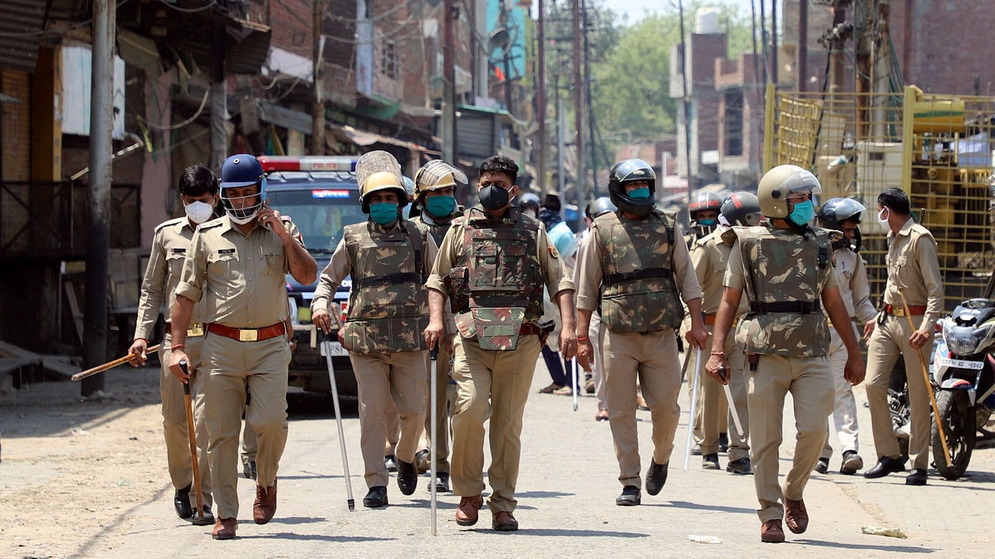 Security personnel patrolling the area in Aligarh where clashes broke out between locals and policemen.&nbsp;