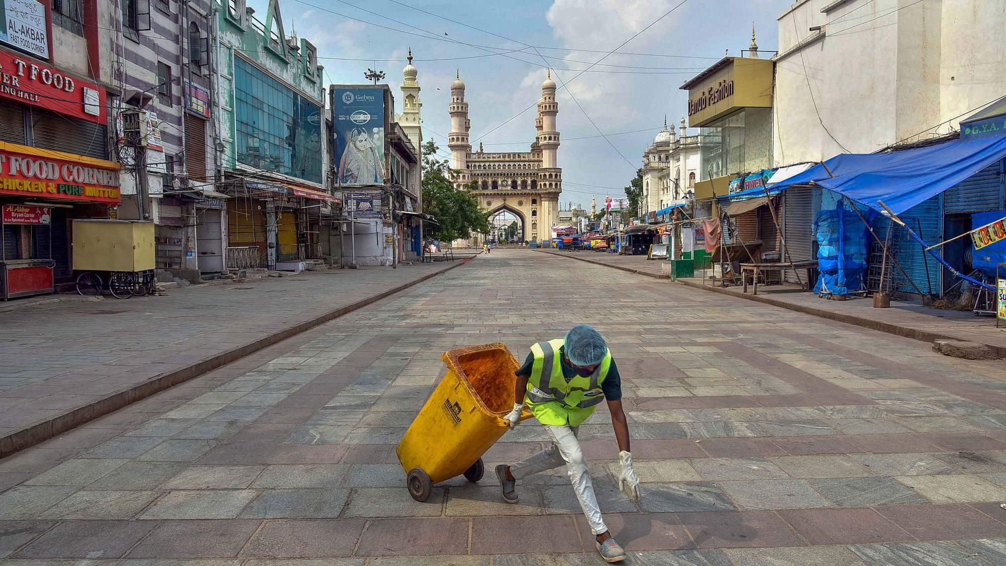  A GHMC worker cleans an area during the nationwide lockdown, imposed in wake of the coronavirus pandemic, in the old city of Hyderabad, Tuesday, 7 April, 2020.
