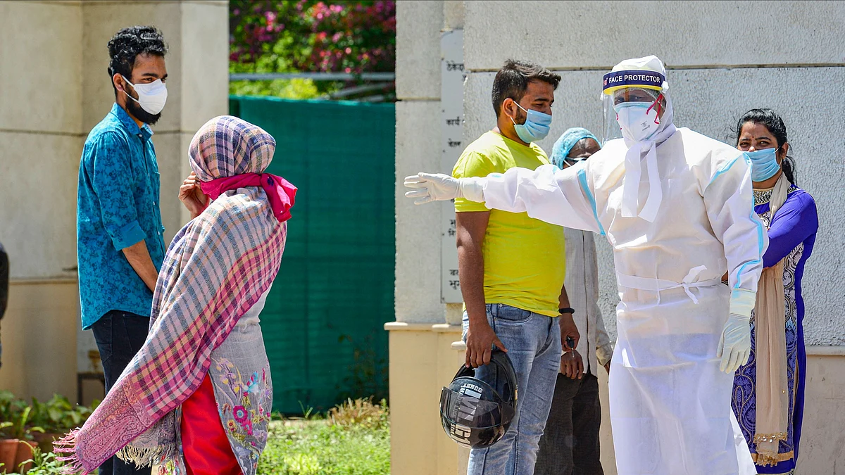 A medic in protective suit instructs people coming to a hospital for check-up. Image used for representational purpose only. 