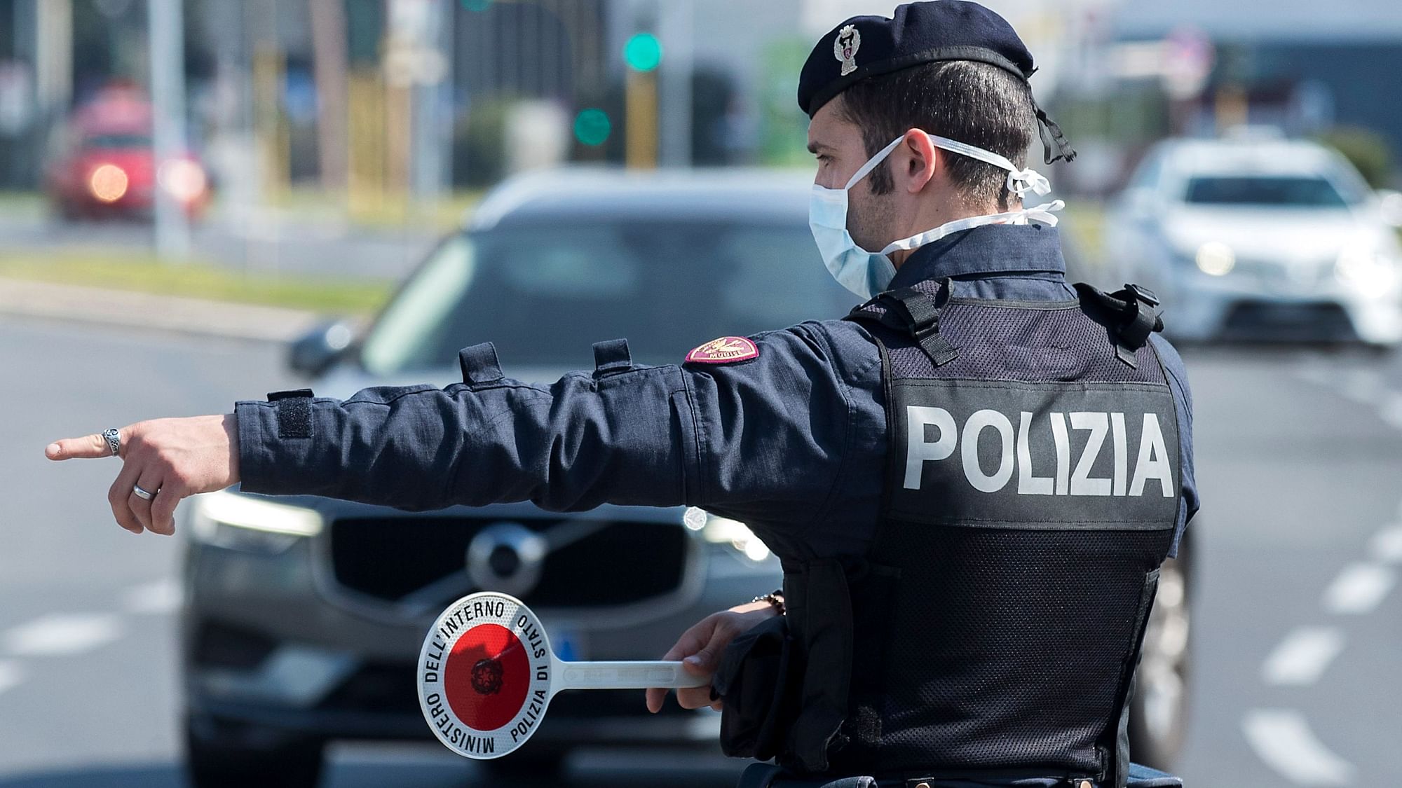 A Police officer stops and check vehicles in Rome, Saturday, April 11, 2020.&nbsp;