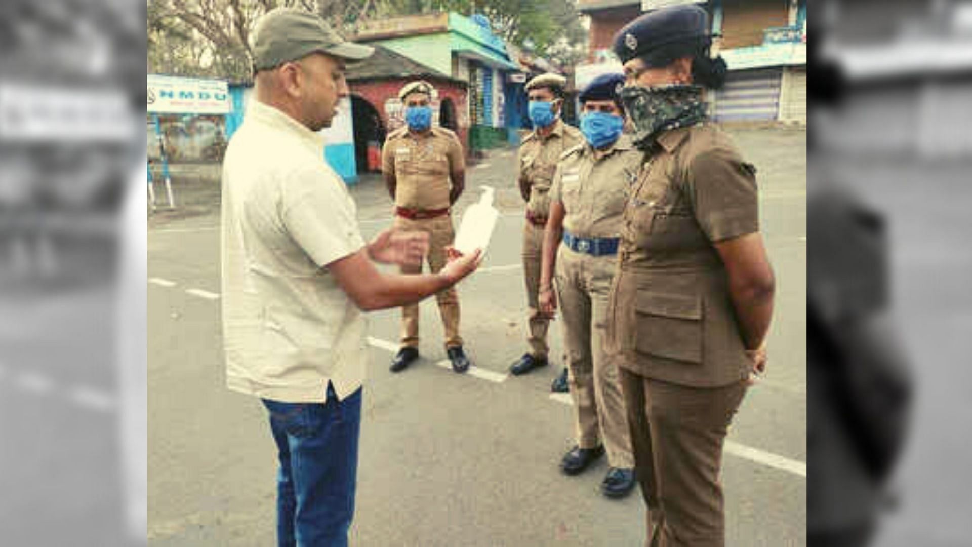 Vikram Mathias distributes hand sanitisers among officials.