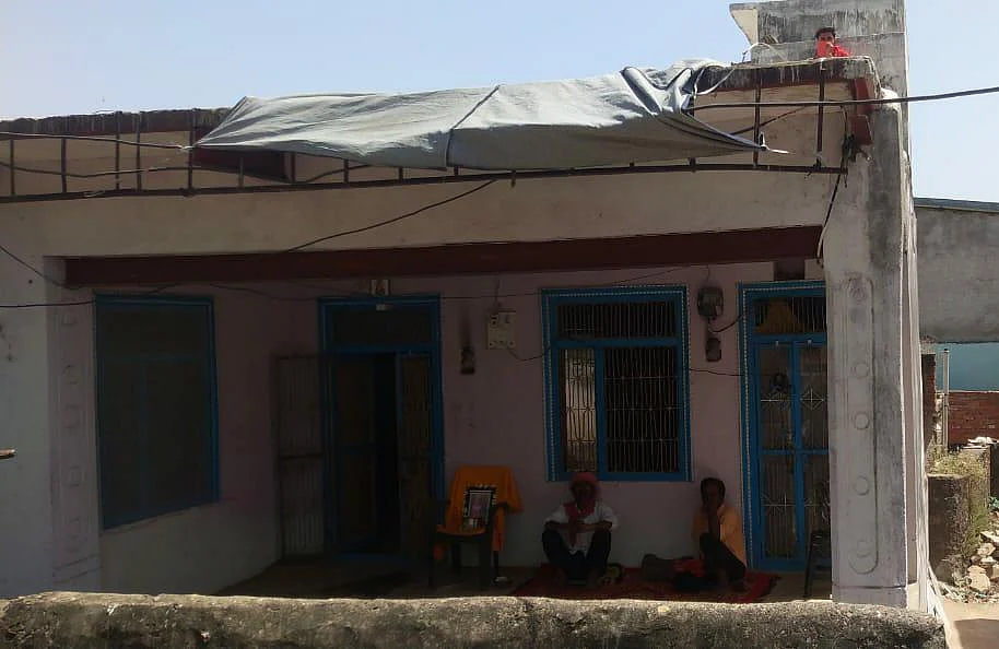 This is Nikhil’s home in Banswara. His father sitting outside with his picture to great the relatives or neighbours who may come in. Due to the lockdown, very few have shown up to offer him support.