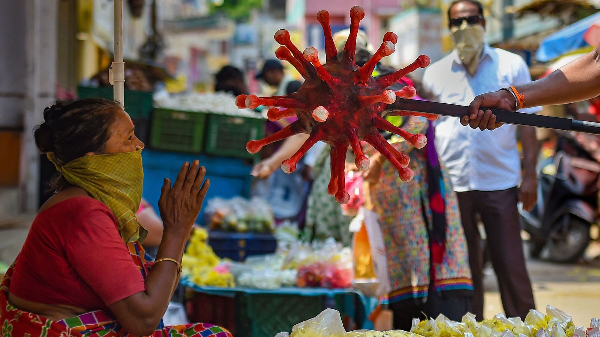 A policeman wearing a coronavirus-themed outfit walks at a market to raise awareness about social distancing, during a government-imposed nationwide lockdown as a preventive measure against the COVID-19, in Chennai, Thursday, 2 April, 2020.