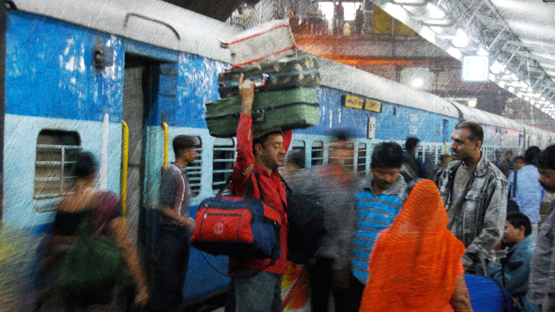 A porter carrying luggage at a Delhi railway station.&nbsp;