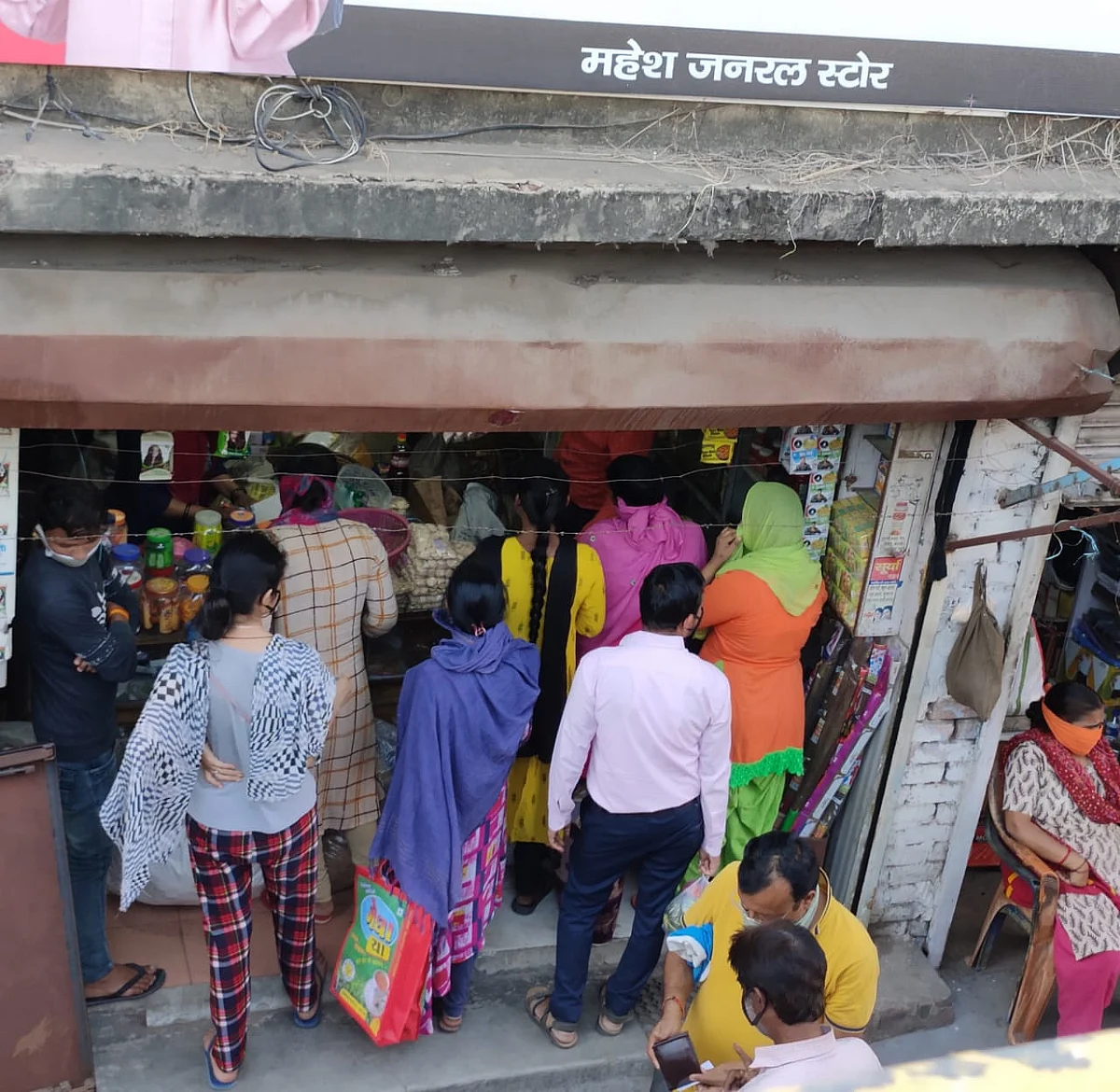 People queue outside a shop in Lucknow's Nishatganj area soon after news reports of hotspots being sealed.
