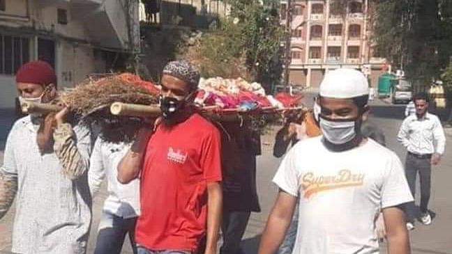Muslim youth carry the bier of a Hindu neighbour amid coronavirus lockdown in Indore.