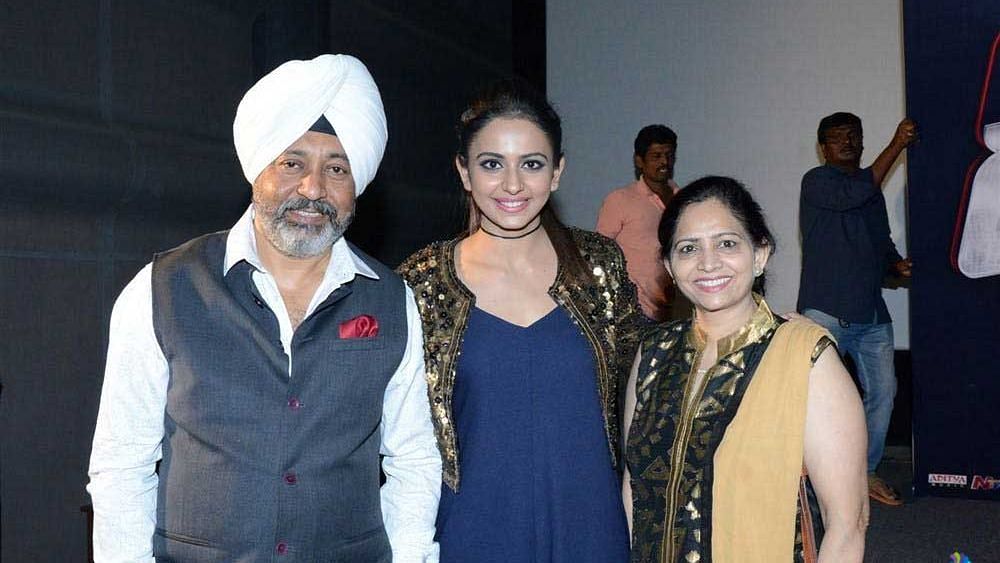 Rakul Preet (in the centre) with her parents.