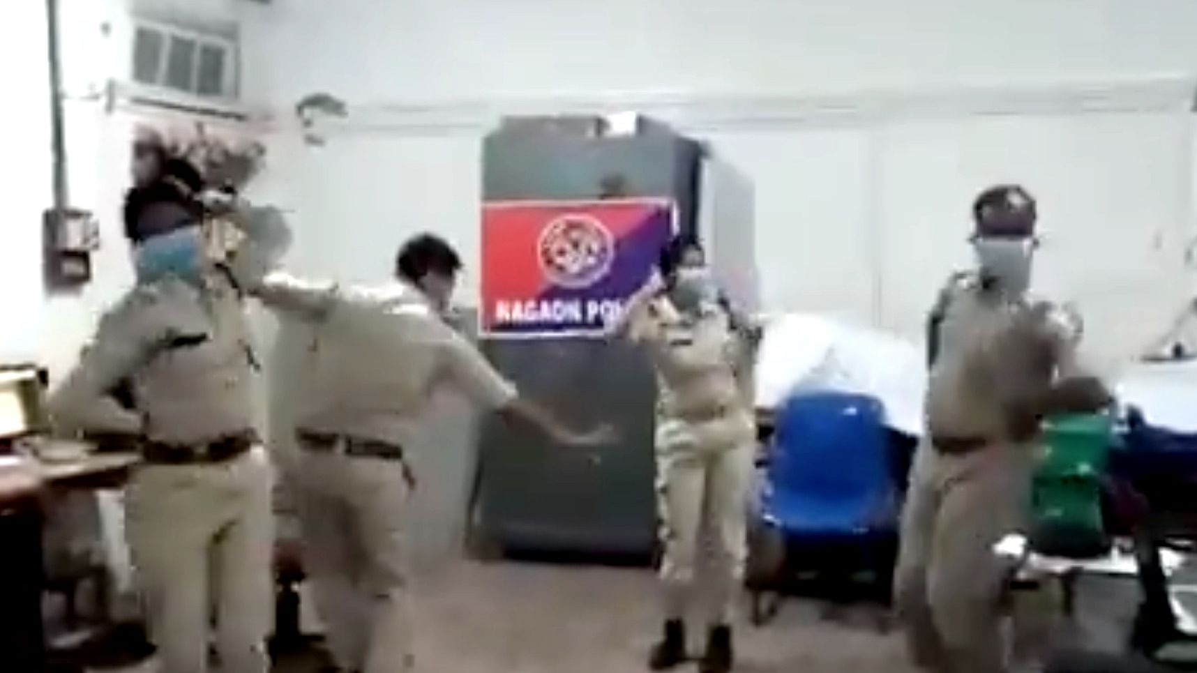 Police personnel break into a Bihu dance.