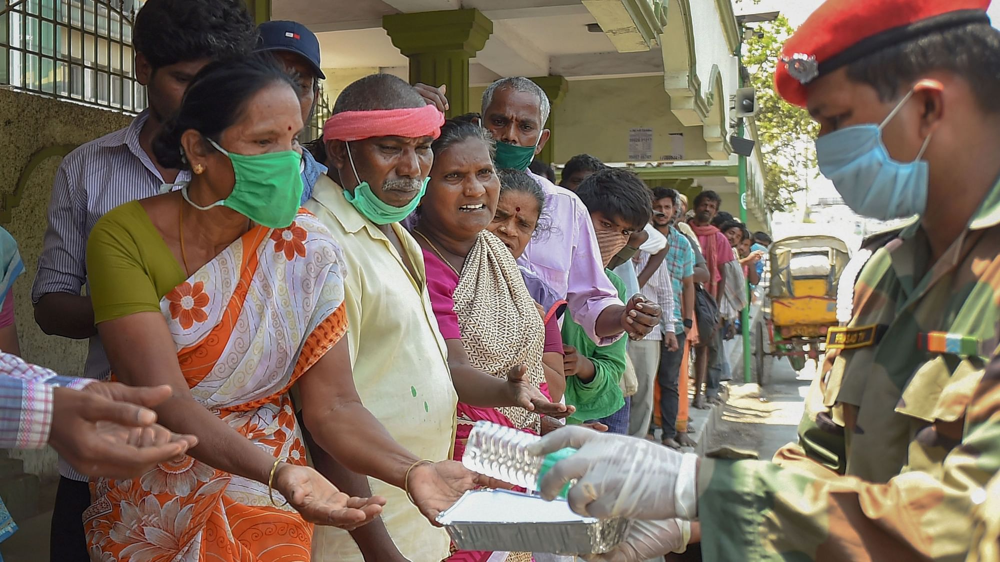 Army personnel distribute packaged food among the homeless and needy people during the nationwide lockdown, in wake of the coronavirus pandemic, in Chennai.