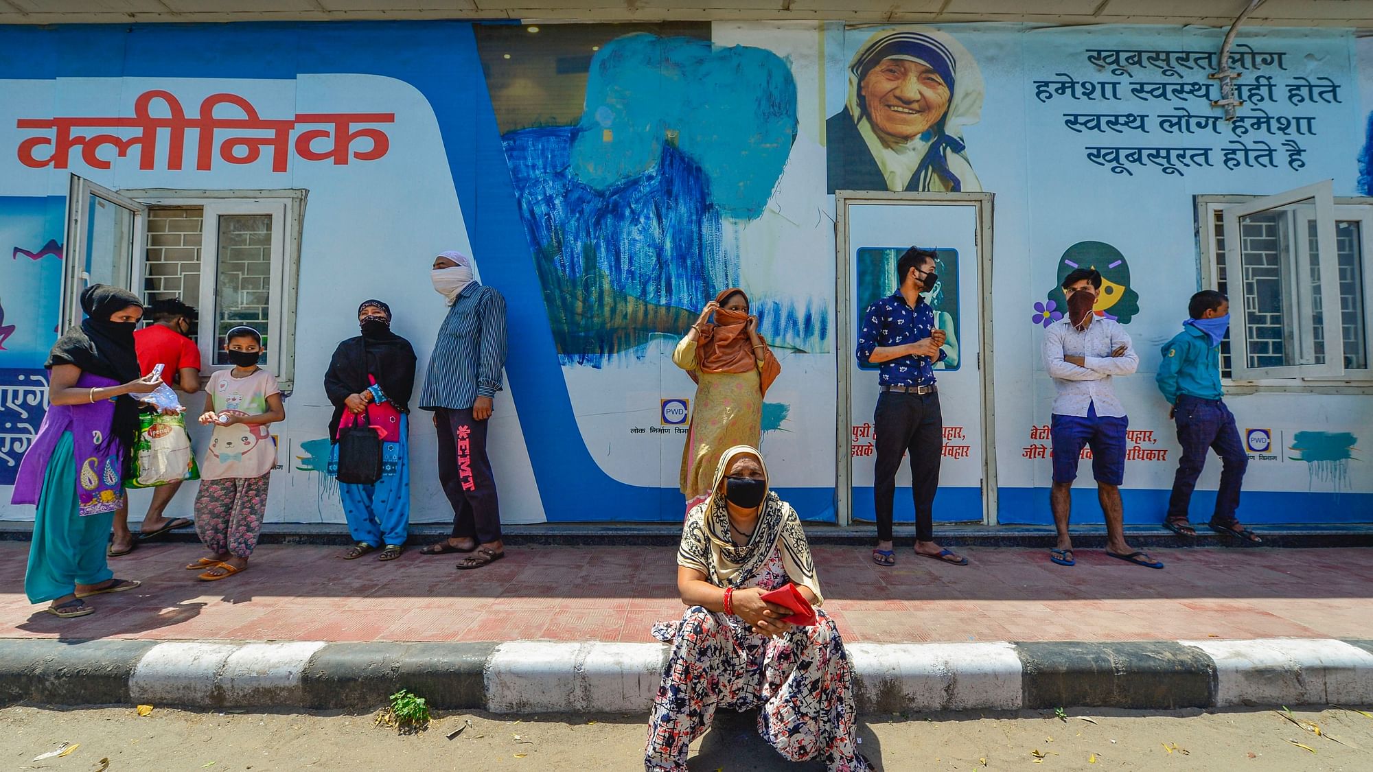 People lined up for check-up outside a clinic run by the Delhi Government during the nationwide lockdown imposed in view of the coronavirus pandemic, in New Delhi, Wednesday, 8 April 2020.