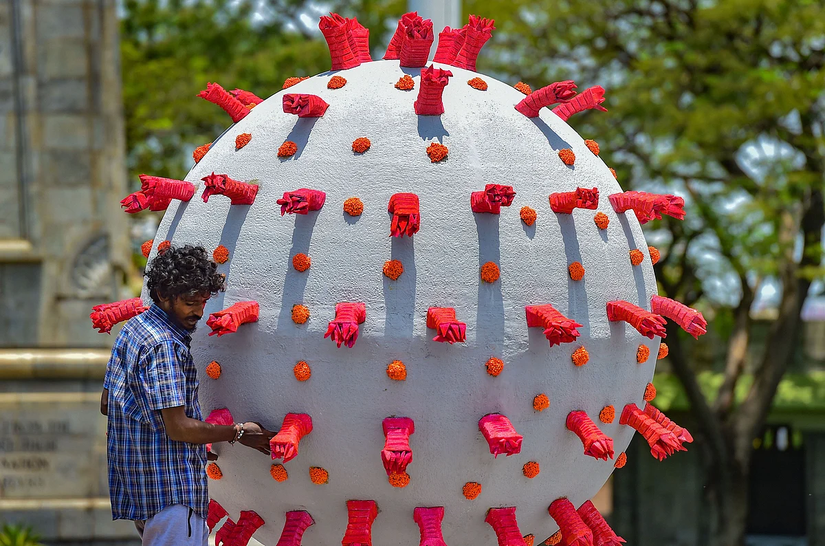 Chennai: An artist gives a final touch to a model based on coronavirus placed alongside a road to raise awareness, during a government-imposed nationwide lockdown, in Chennai, Wednesday, April 29, 2020.