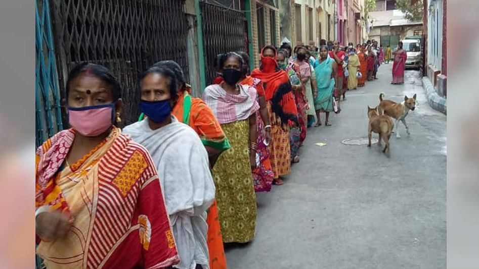 Sex workers and their families in Sonagachi, Kolkata, queue up for food rations distributed by the nonprofit New Light, on 2 April, 2020.&nbsp;