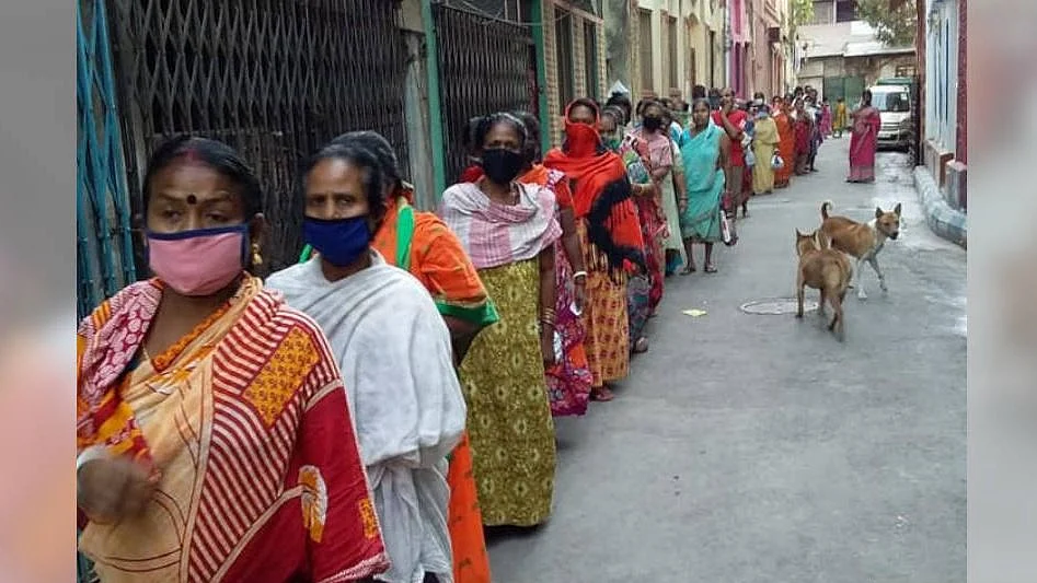 Sex workers and their families in Sonagachi, Kolkata, queue up for food rations distributed by the nonprofit New Light, on 2 April, 2020. 