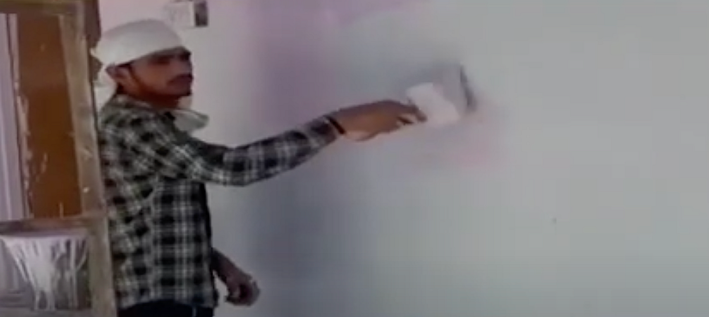 A labourer paints the school walls where has been quarantined.