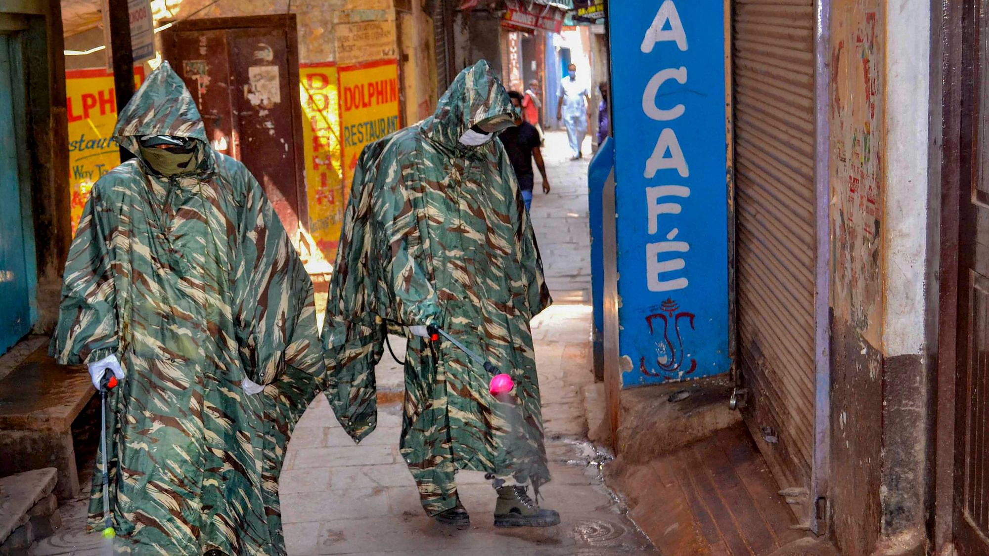 CRPF personnel wearing protective outfits sanitize a street near Dasaswamedh Ghat, Varanasi. Image used for representational purpose only.