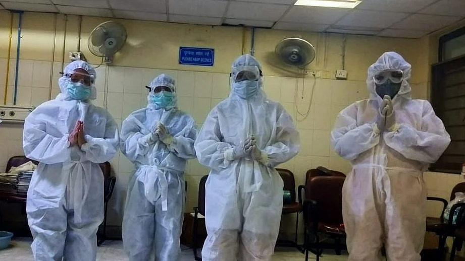 A group of nurses say a prayer before starting their day at a Delhi hospital.